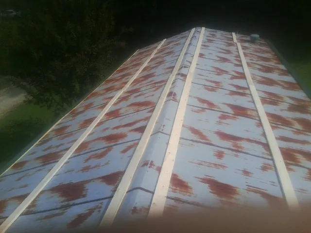 Rusted metal roof panels with new wood purlins before replacement — Storm Damage Roof Repair in Pierz by Roofing Brothers